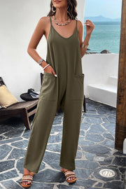Army green relaxed drape pocket jumpsuit with V-neck and spaghetti straps.