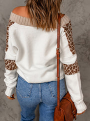 White knit sweater with off-shoulder neckline, leopard print sleeves, and tan trim.