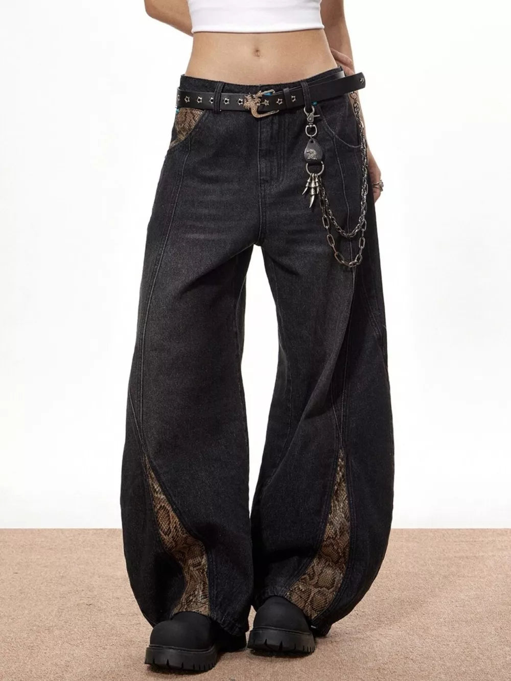 Vintage wide leg black jeans with snake print accents and chain belt.