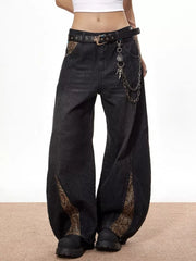 Vintage wide leg black jeans with snake print accents and chain belt.