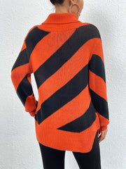 Orange-red and black diagonal stripe turtleneck knit sweater with side slits.