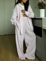 Pinstriped long sleeve pajama set in dusty pink with drawstring pants and button-down shirt.