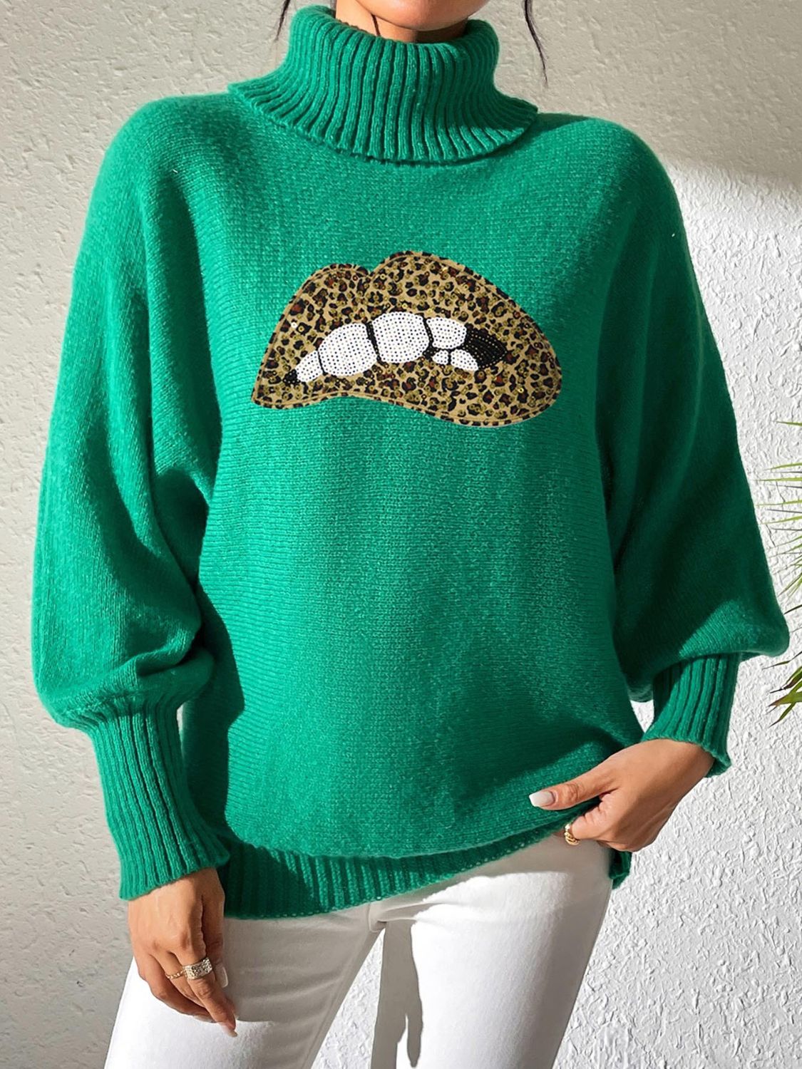 Green turtleneck sweater with sequin lip detail and balloon sleeves
