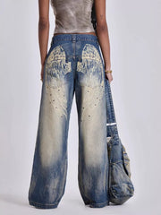 Wide leg jeans in vintage wash blue denim with studded wing back pocket detail.