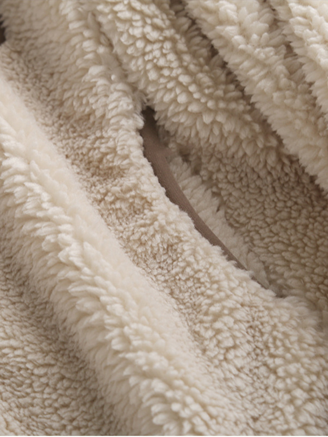 Sherpa zip-up jacket in beige with fuzzy texture and patch pocket detail.