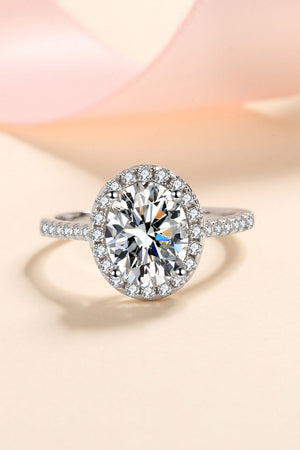 Silver pavé halo solitaire ring with a large center stone on a sterling silver band.