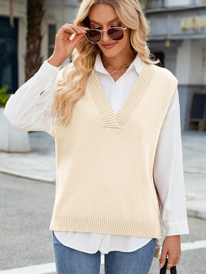 Cream ribbed knit V-neck sweater vest with a classic fit, layered over a white shirt.