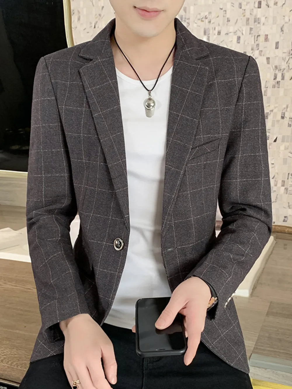 Men's grey plaid sport jacket with button-down closure and notched lapels.