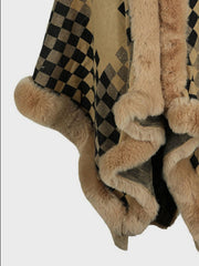 Checkered cape in tan and black acrylic with plush faux fur trim and pom-poms.