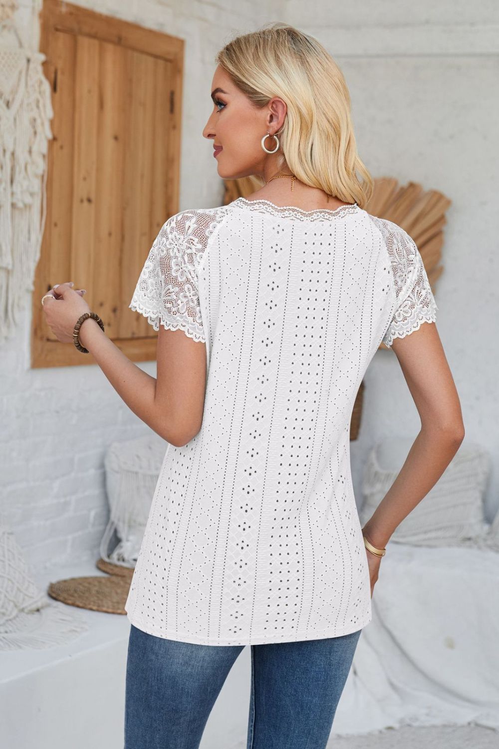 White eyelet raglan blouse with lace short sleeves and scalloped trim.