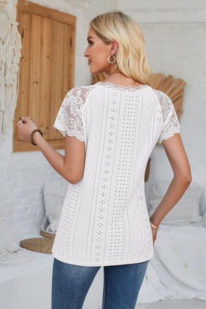 White eyelet raglan blouse with lace short sleeves and scalloped trim.