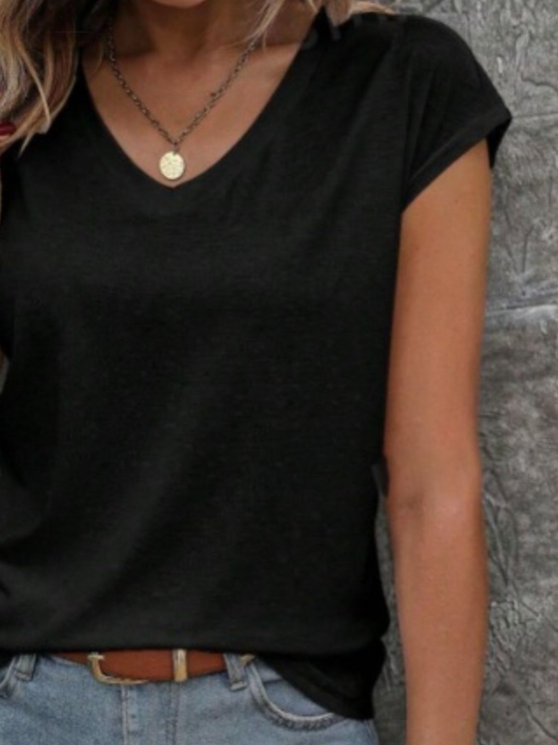 Black cap sleeve slouchy v-neck tee with a casual fit.