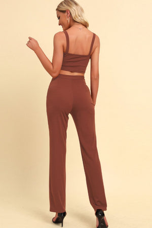 Caramel chain strap crop top and high-waist trousers outfit set.