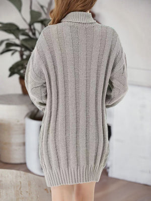 Gray cable knit turtleneck mini dress with ribbed texture and long sleeves.