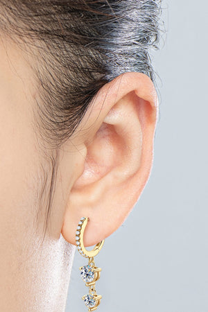 Gold hoop earrings with cascading moissanite drops on a woman's ear