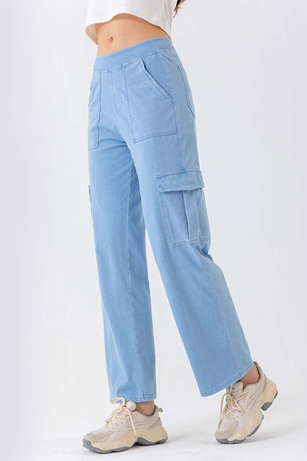 Light wash denim cargo pants with multiple pockets and a relaxed fit.