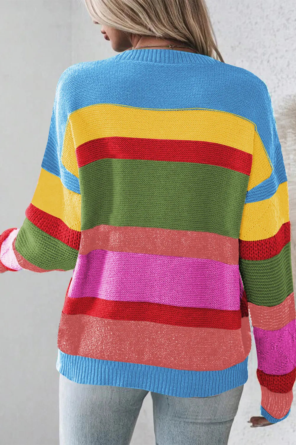 Rainbow stripe knit crewneck sweater with crew neck and long sleeves.
