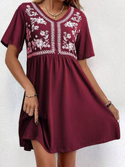 Burgundy embroidered floral v-neck mini dress with short sleeves and a gathered waist.