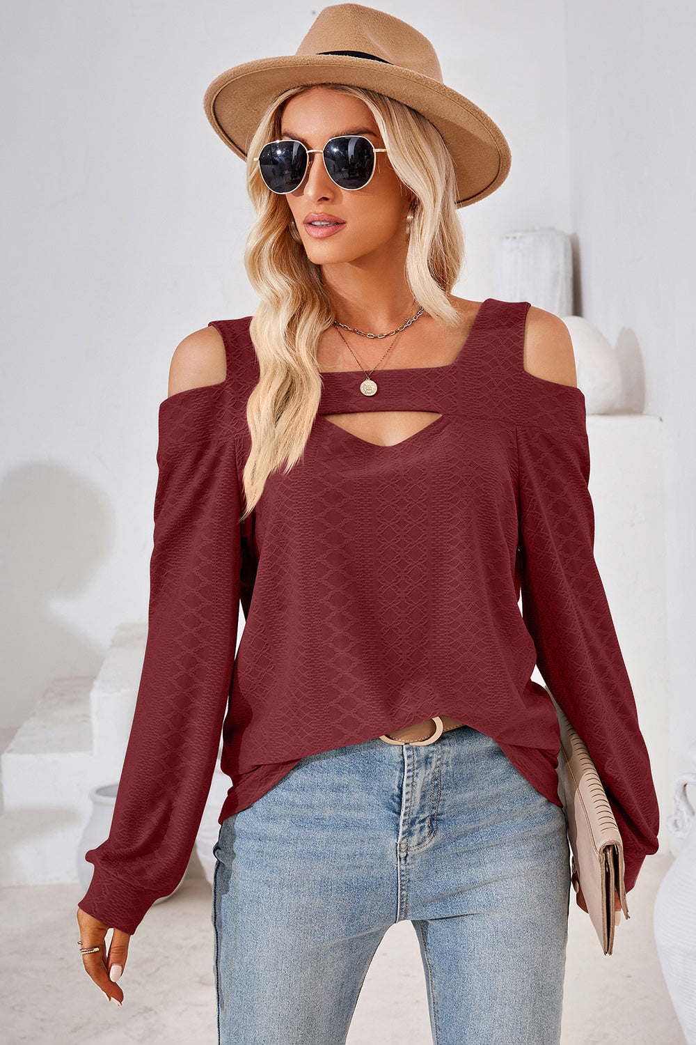 Burgundy geometric cutout shoulder top with long sleeves and a keyhole neckline.