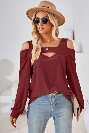 Burgundy geometric cutout shoulder top with long sleeves and a keyhole neckline.