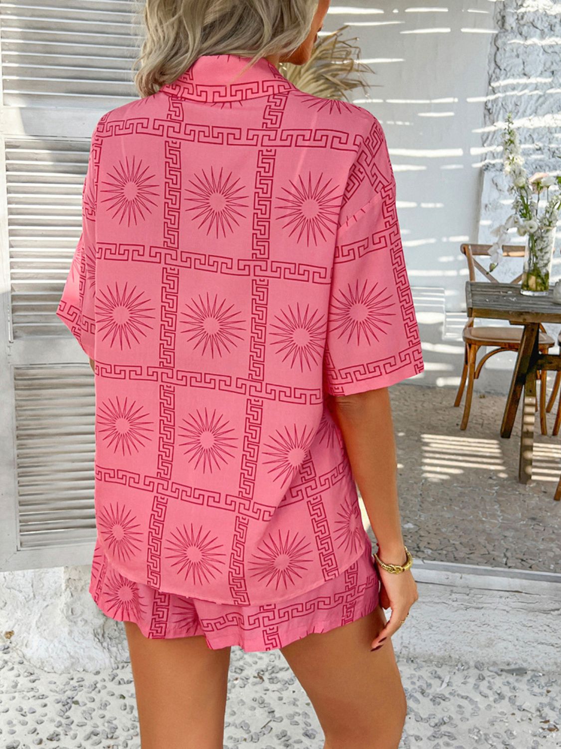 Blush Pink co-ord set with sunburst and Greek key print, short sleeves, collared shirt and shorts.