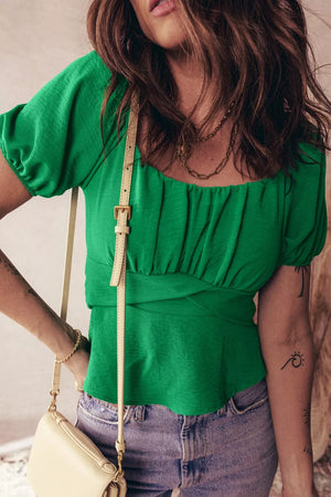 Green ruched crossed waist peplum shirt with puff sleeves and square neckline.