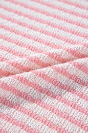 Textured stripe puff sleeve top in blush pink with a seersucker fabric detail.