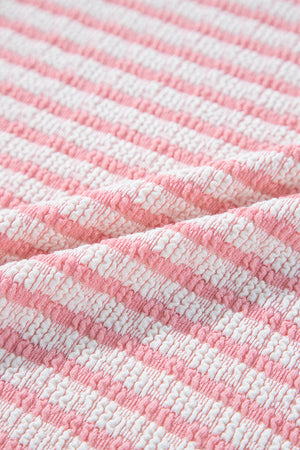 Textured stripe puff sleeve top in blush pink with a seersucker fabric detail.