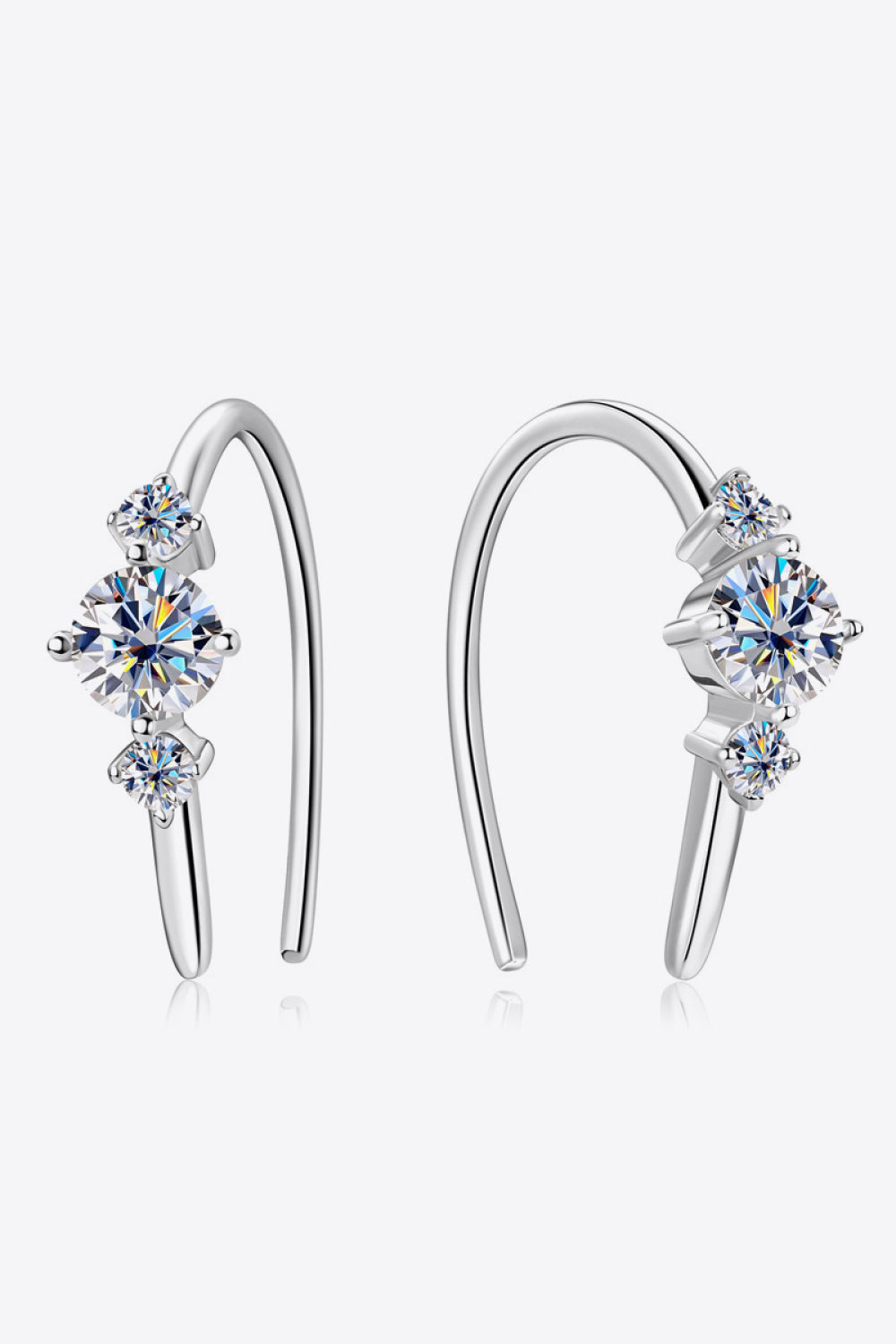 Silver ear climbers with three sparkling diamonds, a celestial design.