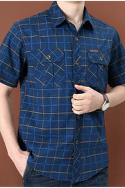 Men's royal blue plaid short sleeve button-down shirt with two chest pockets.