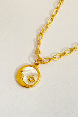 Celestial charm necklace in 18K gold-plated metal with a moon and sun charm.