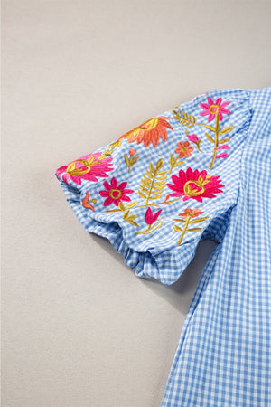 Light blue gingham blouse with embroidered floral puff sleeves