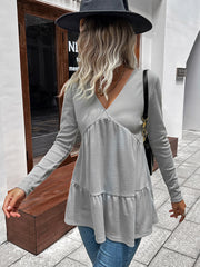 Light gray waffle knit peplum top with V-neck and tiered ruffle hem.