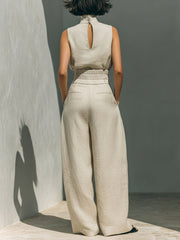 Sleeveless ivory mock-neck top with keyhole back and wide-leg pants with elastic waist.