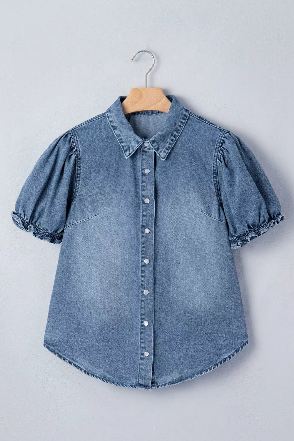 Chic frilled denim shirt with snap closure, puff sleeves, and a collared neckline.