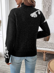 Black acrylic mock neck sweater with white floral embellishments and subtle sparkle detail.