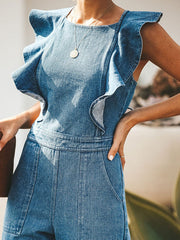 Ruffled denim jumpsuit in medium wash with a crossover back detail.