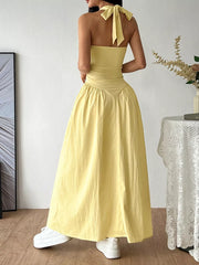 Yellow ruched maxi dress with empire waist and halter tie, casual maternity style