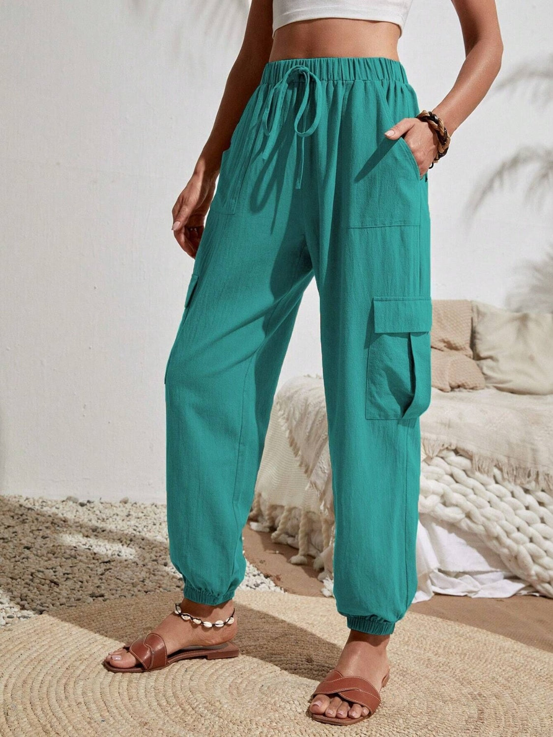 Turquoise textured cargo lounge trousers with drawstring waist and elastic cuffs.