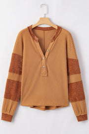 Caramel waffle knit henley top with contrast stripe sleeves and raw edge neckline.
