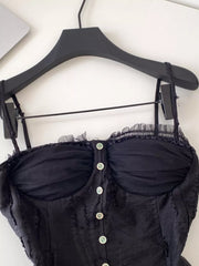 Black lace ruffle hem tank top with button front and sheer bust detail.