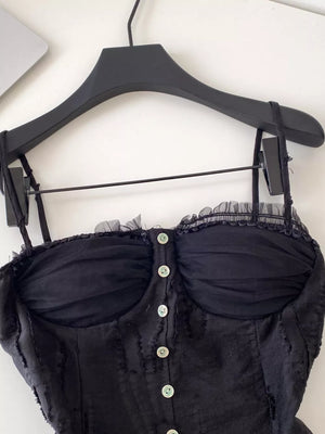 Black lace ruffle hem tank top with button front and sheer bust detail.
