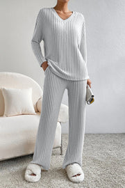 Light gray ribbed knit lounge set with v-neck top and wide-leg pants.