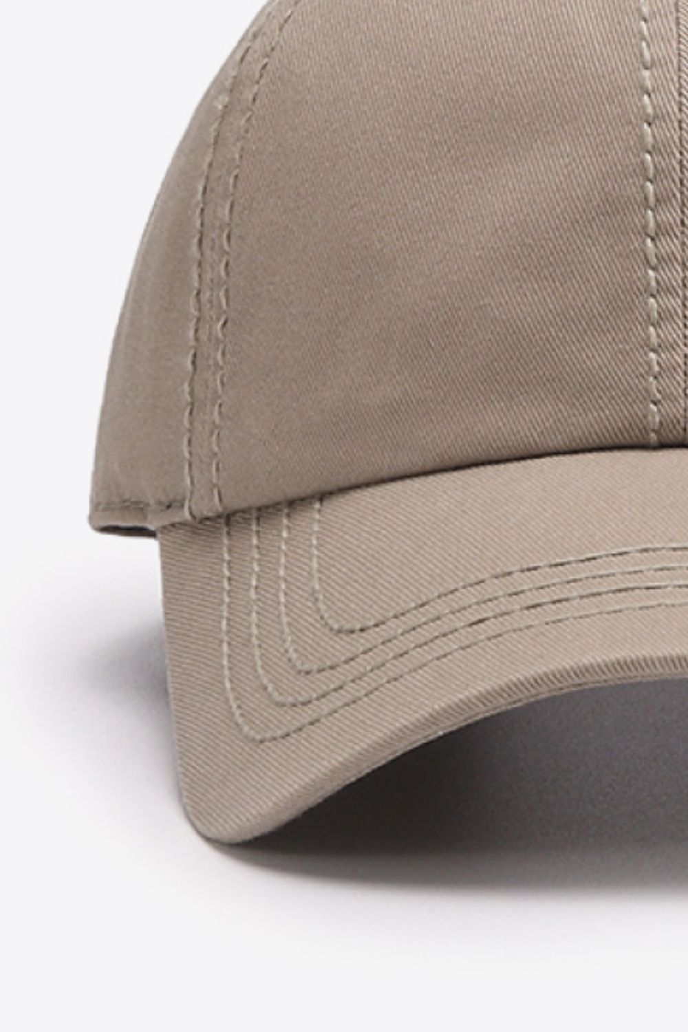 Beige canvas baseball cap with stitched details on crown and brim