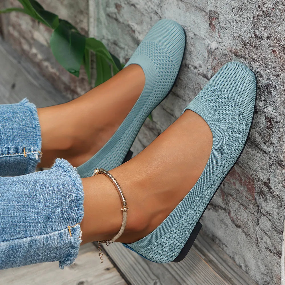 Pastel blue knit square-toe flats with a low heel, styled with cuffed jeans.