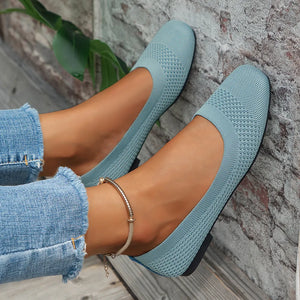 Pastel blue knit square-toe flats with a low heel, styled with cuffed jeans.