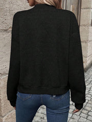 Black geometric quilted bomber jacket with a mock neck and ribbed cuffs.