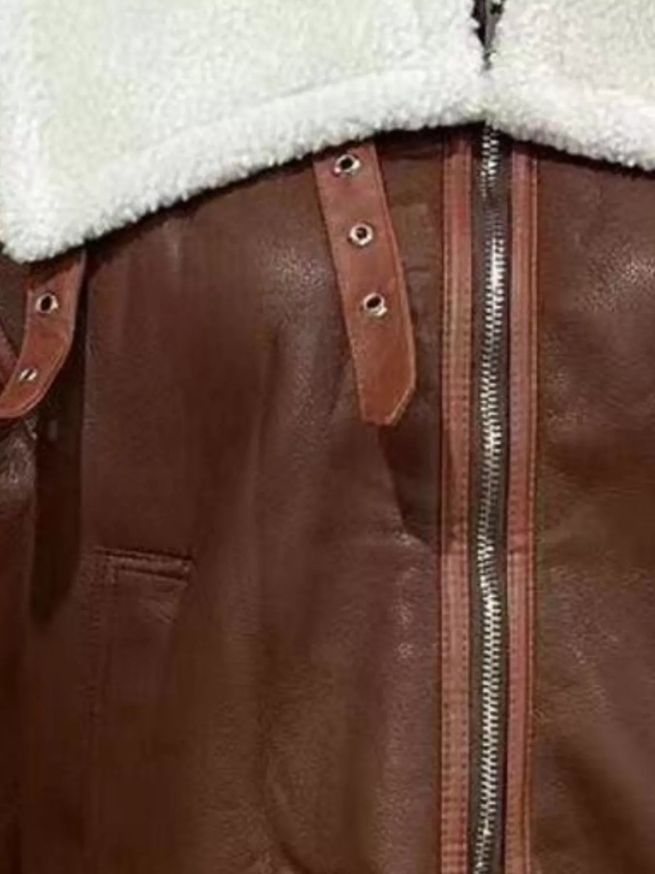Brown shearling lined zip up jacket with leather details and buckles.