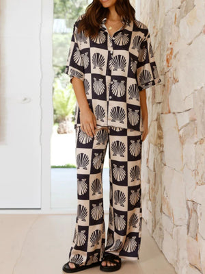 Black shell print silk pajama set with buttoned shirt and wide leg pants