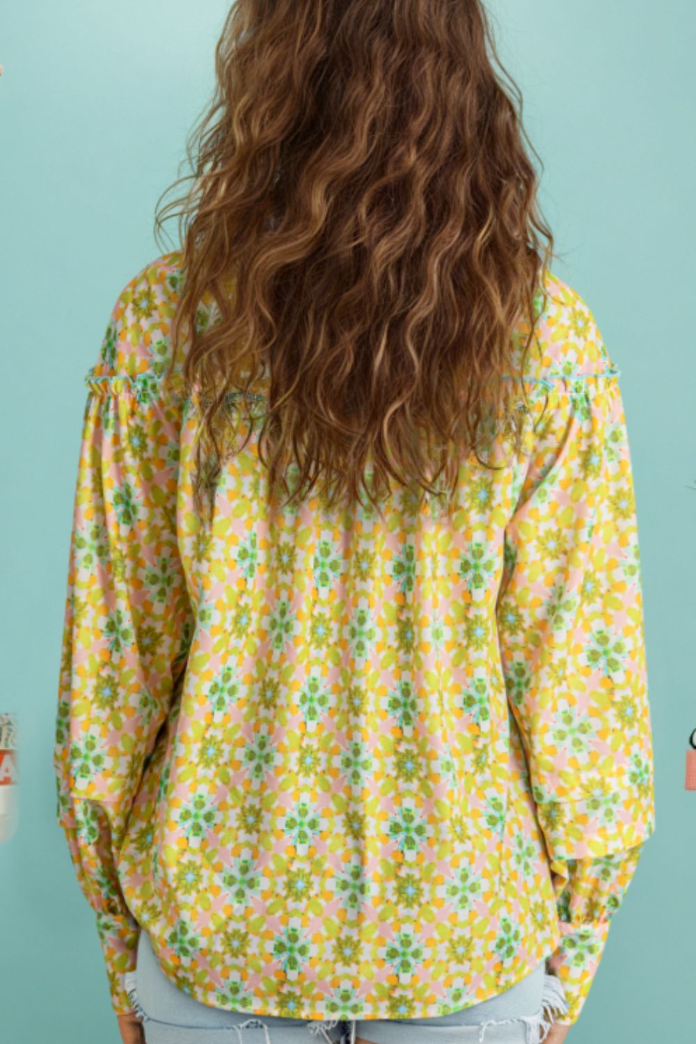 Yellow green floral ruffle yoke button-down blouse with long sleeves.